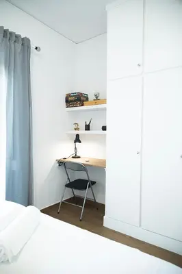 a bedroom with a desk and a bed and a desk and a chair at Sea Front Sophia Porto Rafti in Porto Rafti