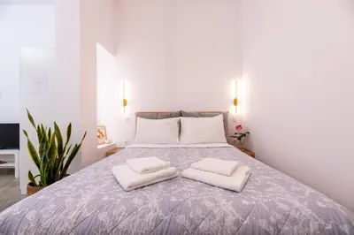 a bedroom with a bed with two white pillows at Valhalla - Brand New Airport Apt. in Spáta