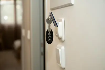 a key on a door with a keychain at Anesis Airport rooms 306 in Koropíon
