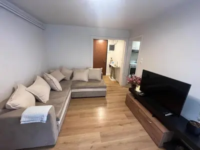 a living room with a couch and a flat screen tv at Διαμέρισμα δίπλα από την θάλασσα in Athens