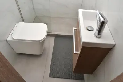 a bathroom with a white toilet and a sink at Διαμέρισμα δίπλα από την θάλασσα in Athens