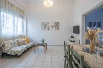 a living room with a couch and a table at Piraiki Coastal Accommodation in Piraeus