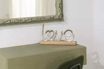 two metal hearts on top of a dresser under a mirror at Piraiki Coastal Accommodation in Piraeus