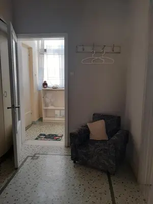 a living room with a couch and a chair at Retro comfy home near Monastiraki in Athens