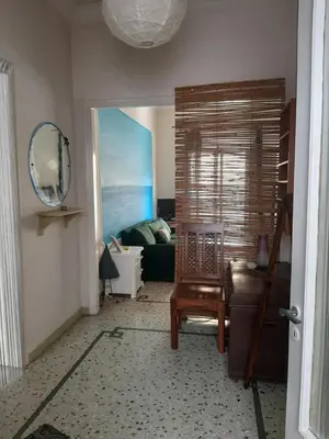 a living room with a couch and a mirror at Retro comfy home near Monastiraki in Athens