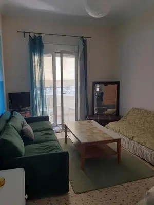 a living room with a couch and a coffee table at Retro comfy home near Monastiraki in Athens