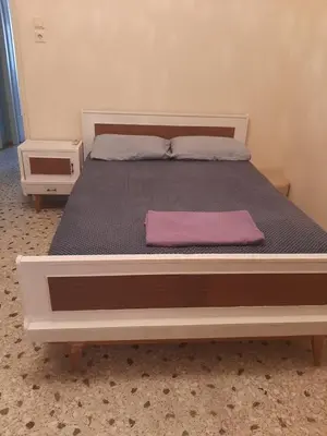 a bed in a room with a pink pillow on it at Retro comfy home near Monastiraki in Athens
