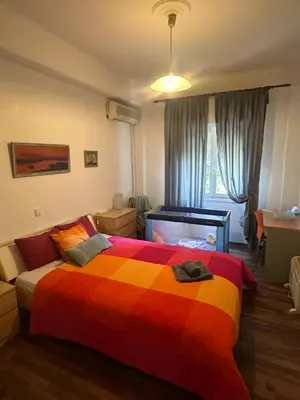 a bedroom with a bed with a colorful blanket at Διαμερίσμα με 1 κρεβατοκάμαρα και ένα σαλόνι in Athens