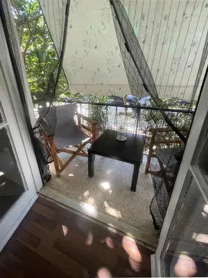 a view of a porch with a table and a chair at Διαμερίσμα με 1 κρεβατοκάμαρα και ένα σαλόνι in Athens