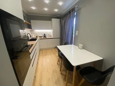 a small kitchen with a white table and chairs at Comfortable Apartment Near to Metro in Athens