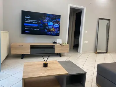a living room with a large flat screen tv on the wall at Comfortable Apartment Near to Metro in Athens
