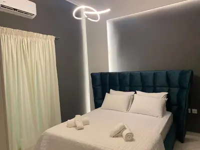 a bedroom with a bed with two towels on it at Comfortable Apartment Near to Metro in Athens