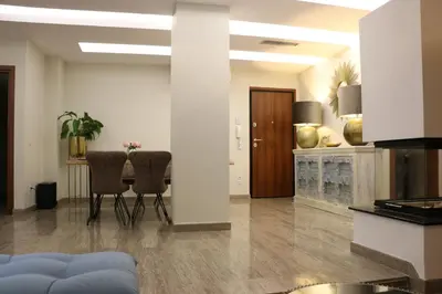 a living room with two chairs and a table at Exzellent ApartAthens 120qm, near Metro M2 in Athens