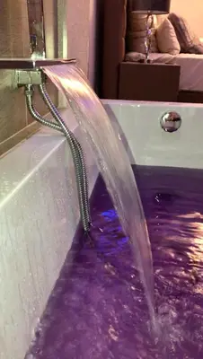 a bathtub with a water hose coming out of it at Exzellent ApartAthens 120qm, near Metro M2 in Athens