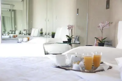 a table with a tray of food and orange juice at X Dream Hotel-Adults Only in Athens