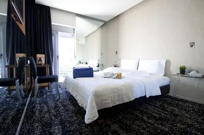 a bedroom with a large bed with white sheets at X Dream Hotel-Adults Only in Athens