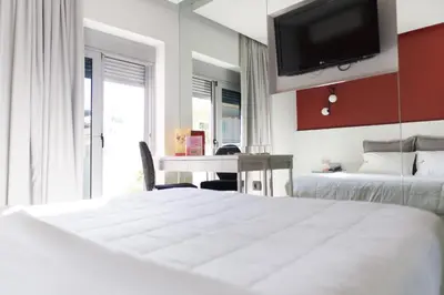 a bedroom with a bed and a desk and a tv at X Dream Hotel-Adults Only in Athens
