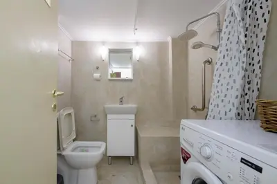 a bathroom with a toilet and a sink and a shower at Cosy 2BR flat near Ampelokipoi station & hospitals in Athens