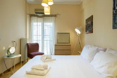 a bedroom with a bed with two towels on it at Cosy 2BR flat near Ampelokipoi station & hospitals in Athens