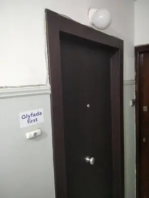 a black door with a sign that reads givalry first at Glyfada First Center in Athens