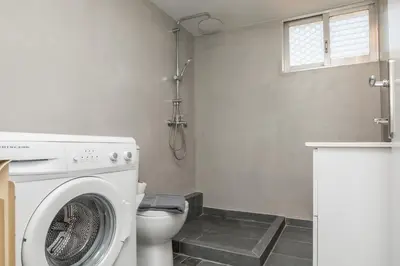a bathroom with a washing machine and a toilet at Saronicos Gulf View in Anavissos in Anavissos