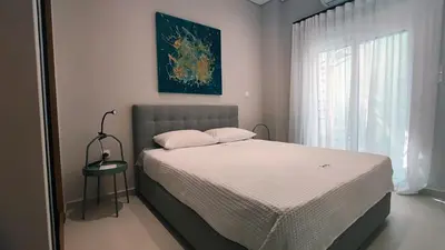 a bedroom with a bed and a window at Luxury Apartment Stella in Piraeus