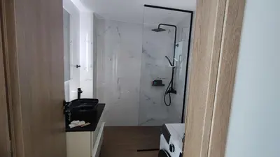 a bathroom with a shower and a toilet and a sink at Luxury Apartment Stella in Piraeus