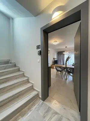a hallway with a door leading to a dining room at Athenean Oasis in Ellinikon in Athens