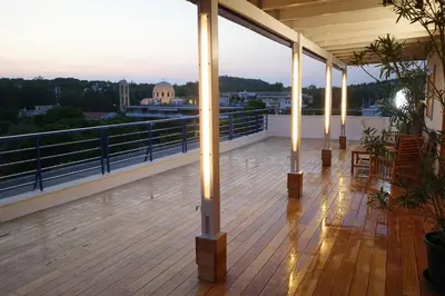 a balcony with lights on the roof of a building at Best view in the Bay! in Athens