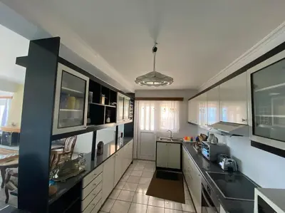 a large kitchen with black and white appliances at Eagles Nest Villa Athenian Riviera in Aghia Marina near Lagonisi, next to the beach close to Athens Airport in Aghia Marina
