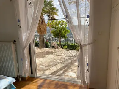 an open door with a view of a patio at Eagles Nest Villa Athenian Riviera in Aghia Marina near Lagonisi, next to the beach close to Athens Airport in Aghia Marina