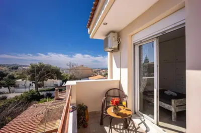 a balcony with a table and chairs and a view at Mountain-to-Sea Oasis in Kalívia Thorikoú