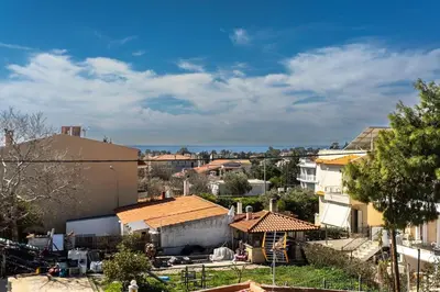 a view of a city with houses and trees at Mountain-to-Sea Oasis in Kalívia Thorikoú