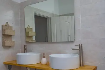 a bathroom with a white sink and a mirror at dreamcatcher in Anavissos