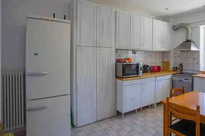 a kitchen with white cabinets and a white refrigerator at dreamcatcher in Anavissos
