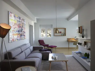 a living room with a couch and a table at Scale Suites in Athens