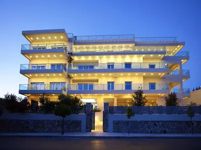 a large building with lights on it at night at Scale Suites in Athens