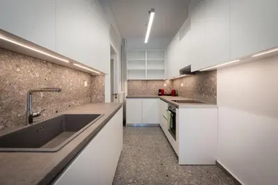 a kitchen with white cabinets and a sink at LIV - Paradise Retreat in Athens in Athens