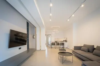 a living room with a couch and a table at LIV - Luminous & Spacious in Pagrati in Athens