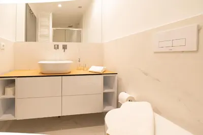a white bathroom with a sink and a toilet at LIV - Luminous & Spacious in Pagrati in Athens