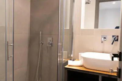 a bathroom with a sink and a shower at LIV - Luminous & Spacious in Pagrati in Athens