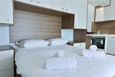 a bedroom with two white towels on a bed at LIV - View and the City Studio in Athens in Athens