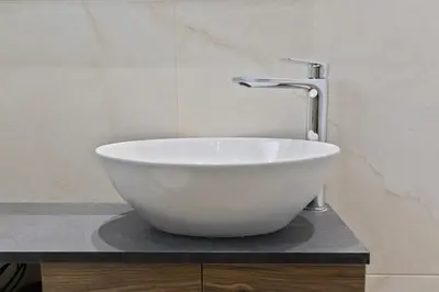 a white bowl on a counter with a faucet at LIV - View and the City Studio in Athens in Athens