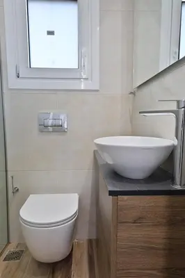 a bathroom with a sink and a toilet and a window at LIV - View and the City Studio in Athens in Athens