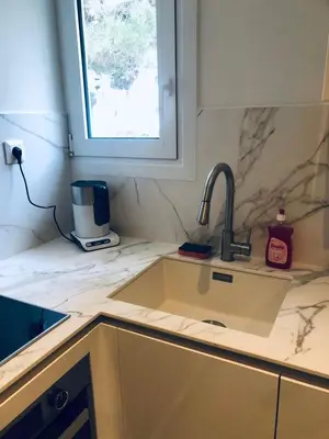 a kitchen counter with a sink and a window at SeaRenity Glyfada Ctr, 1BR, Renovated, near beach in Athens