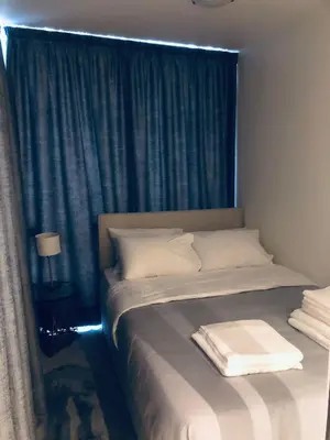 a bedroom with a bed with a blue curtain at SeaRenity Glyfada Ctr, 1BR, Renovated, near beach in Athens