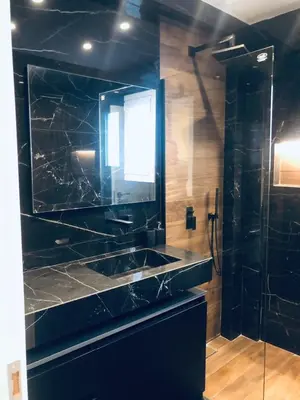 a black bathroom with a sink and a shower at SeaRenity Glyfada Ctr, 1BR, Renovated, near beach in Athens