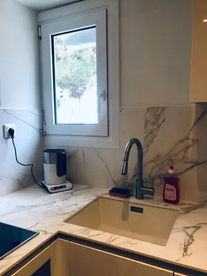 a kitchen counter with a sink and a window at SeaRenity Glyfada Ctr, 1BR, Renovated, near beach in Athens