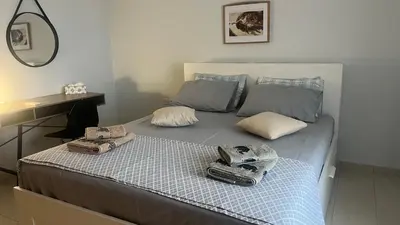 a bed with two towels on top of it at Amaryllis Apartments in Vravrona