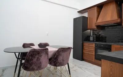 a kitchen with a table and two chairs in a kitchen at The Aeolian in Athens